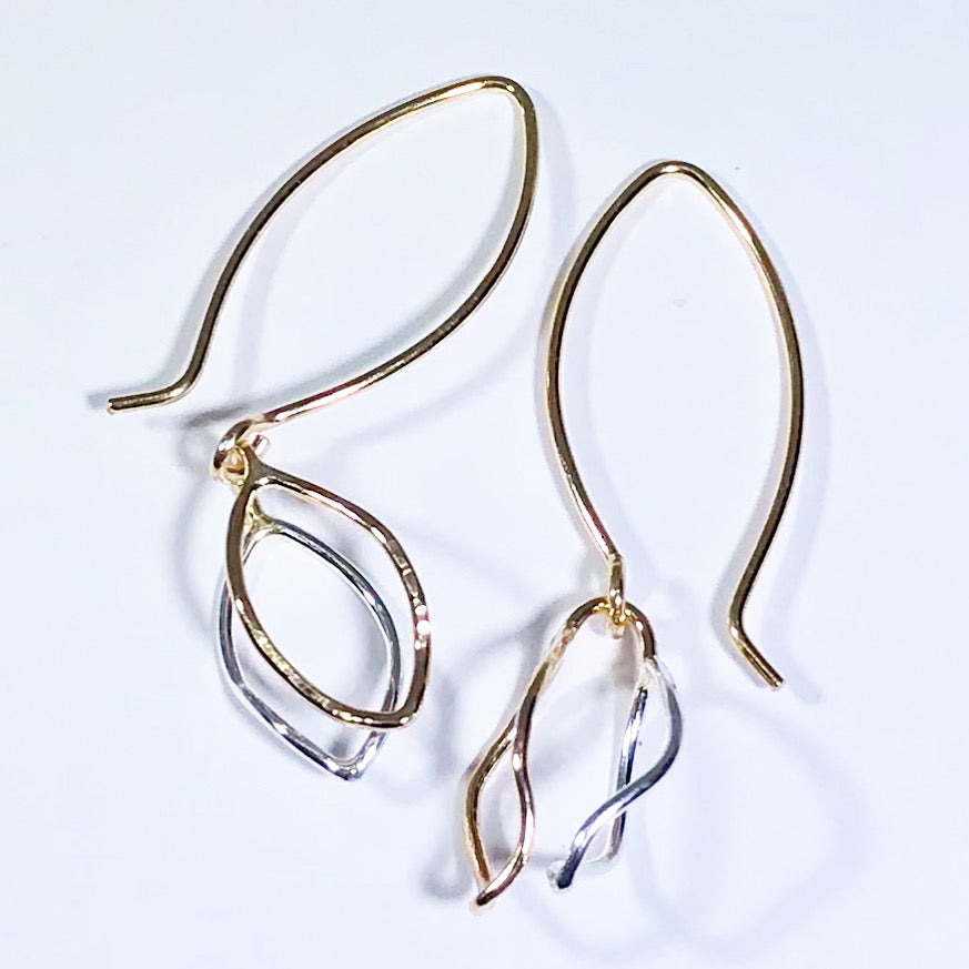 Beautiful earrings with assemblage of charms inside the shape of a square