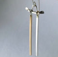 Handmade demi-fine dangle earrings resemble tori